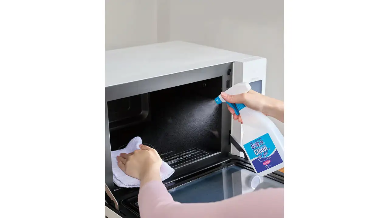 商品『スーパー電解水』を使って電子レンジの内部を掃除する女性